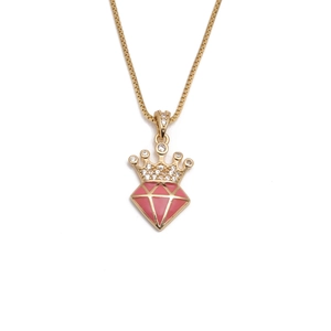 Detail of gold crown necklace featuring pink rhombic gem and clear zircon inlay