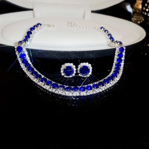 Close-up of luxury double-layer necklace and earrings with blue zircon stones in black gift box