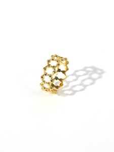 Macro detail of 18k gold plated stainless steel ring with hexagonal honeycomb hollow design