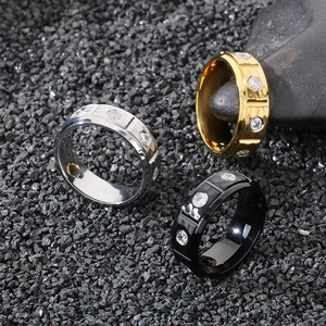 Macro detail of 8mm textured titanium steel rings with inlaid stones in three colors
