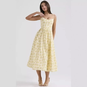 Floral spaghetti strap long dress with open back and A-line silhouette in light yellow