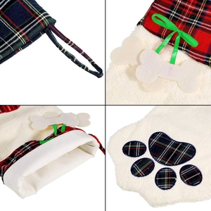 Close-up of pet Christmas stockings with dog bone charm and red plaid paw pattern