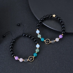 Detail of Libra zodiac bracelets with blue goldstone and stars on a black tray