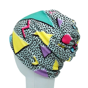Detail of colorful vintage geometric print beanie with retro pop art patterns on a model