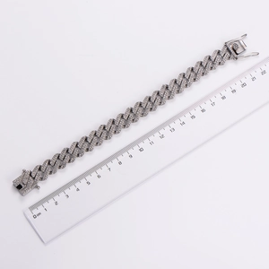 Detailed view of silver iced out Cuban link bracelet next to a ruler showing 21cm length
