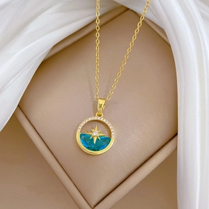 Elegant gold celestial necklace featuring a blue crystal pendant and sparkling star accents