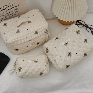Detailed set of three bear-print corduroy storage bags with quilted diamond pattern