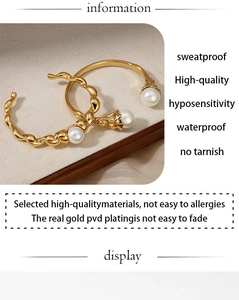 Detail of PVD 18K gold plated stainless steel texture and pearl inlay on a hoop earring