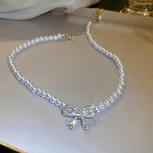 French vintage pearl necklace with a sparkling bow pendant and gold adjustable lobster clasp