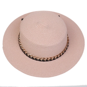 Close-up of pink straw hat featuring high-quality weaving and a golden chain band