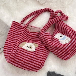 Detail showing two sizes of plush striped tote bags with 3D cartoon dog embroidery