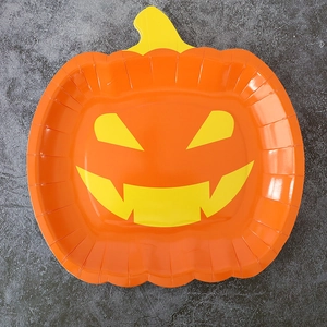 Close-up of orange pumpkin shaped paper plate for Halloween party table decoration