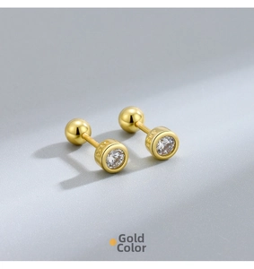 Detailed macro view of gold-plated S925 sterling silver screw-back earrings with zircon