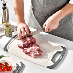 Double-sided non-slip plastic cutting board in beige with grey edges for kitchen use