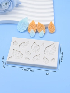 Detail of leaf-shaped silicone fondant mold with precise dimensions and finished resin pieces