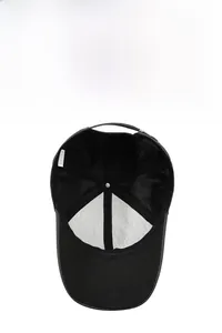 Close-up of breathable mesh lining and adjustable strap on a black baseball cap