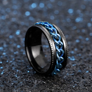 Macro shot of rotatable blue chain inlay on a black stainless steel ring band