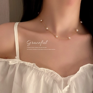Elegant gold plated necklace featuring dainty freshwater pearls on a delicate chain