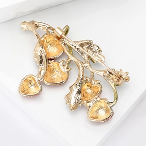 Elegant gold-tone strawberry branch brooch with four red fruits and pin closure