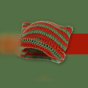 Close-up of red and green striped knit beanie with pointed devil ear details