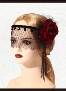 Detail of gothic black mesh veil with red rose and beaded fringes for party costume