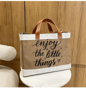 Detail view of burlap tote with leather handles and enjoy the little things print