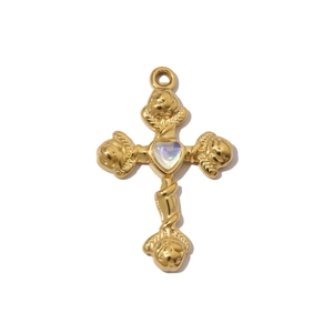 Macro detail of gold-plated stainless steel cross pendant with opal heart and roses
