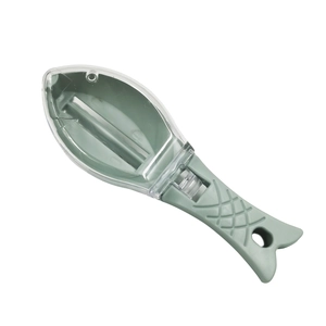 Grey fish-shaped manual descaler with transparent lid and ergonomic plastic handle