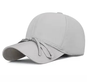Detail of light grey quick-dry baseball cap featuring a decorative fabric bow accent