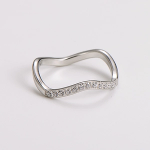 Macro detail of wave-shaped stainless steel ring with micro-pave cubic zirconia accents