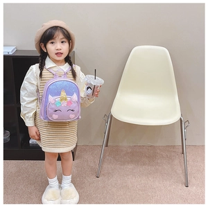 Toddler girl wearing a purple sequin unicorn backpack with gold horn and floral detail