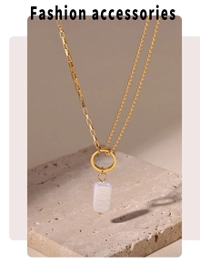 Detail of 18k gold plated dual-chain necklace with rectangular pearl pendant on stone