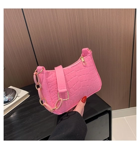 Detailed view of pink crocodile pattern handbag with stylish thick resin chain strap