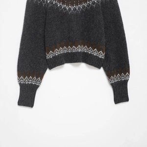 Dark grey Fair Isle knit sweater with vintage geometric patterns and ribbed cuffs