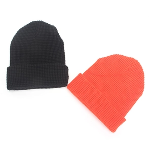 Two-pack of thick waffle knit beanies in black and orange for winter warmth