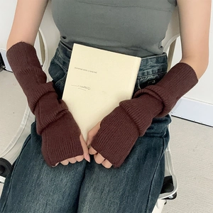 Detail of dark brown ribbed knit arm warmers styled with casual winter clothing