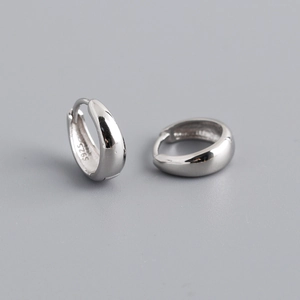 Macro shot of S925 sterling silver hallmark on the polished wide band hoop earrings