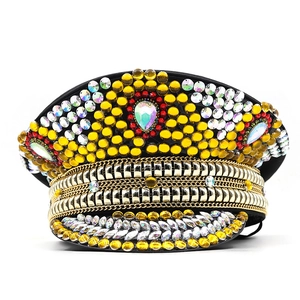 Detail of military party hat with yellow rhinestones, gold chains, and colorful gem