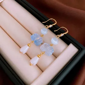 Gold plated lotus zircon earrings with light blue cat eye stones and lily charms