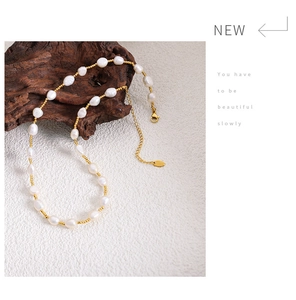 Detail of baroque pearl and gold bead necklace with lobster clasp and extension chain