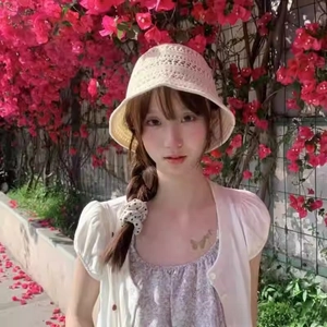 Close-up of cream crochet bucket hat with hollow knit texture on a female model