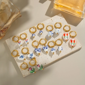 Vintage gold hoop earrings with colorful enamel ceramic flower and heart pendants
