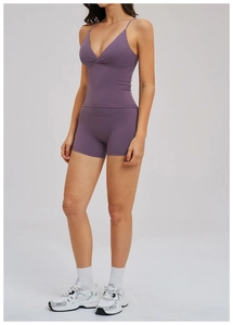 Detail showing back design of purple yoga set with V-neck tank top and biker shorts
