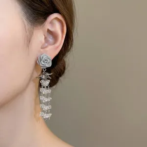 Elegant silver rose earrings with long sparkling crystal tassels and a romantic floral design