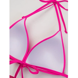Detailed macro view of the padded interior and secure ties on this neon pink bikini top