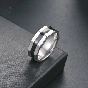 Close-up detail of a minimalist titanium steel ring with a black enamel drip band