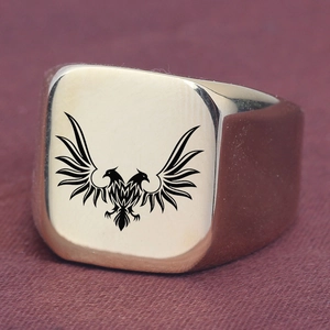 Close-up of golden square signet ring with engraved double-headed eagle on a velvet background