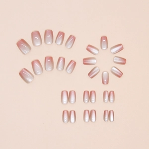 Macro detail of gradient pink cat eye press-on nails in short round square shape
