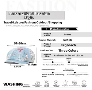 Detail view of denim beret with floral embroidery and size specifications for women
