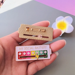 Interactive social battery sliding enamel pin in purple showing emotional energy levels